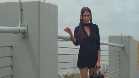 a young girl with red heels on a rooftop in the caribbean city of port of spain with blue skies in the background