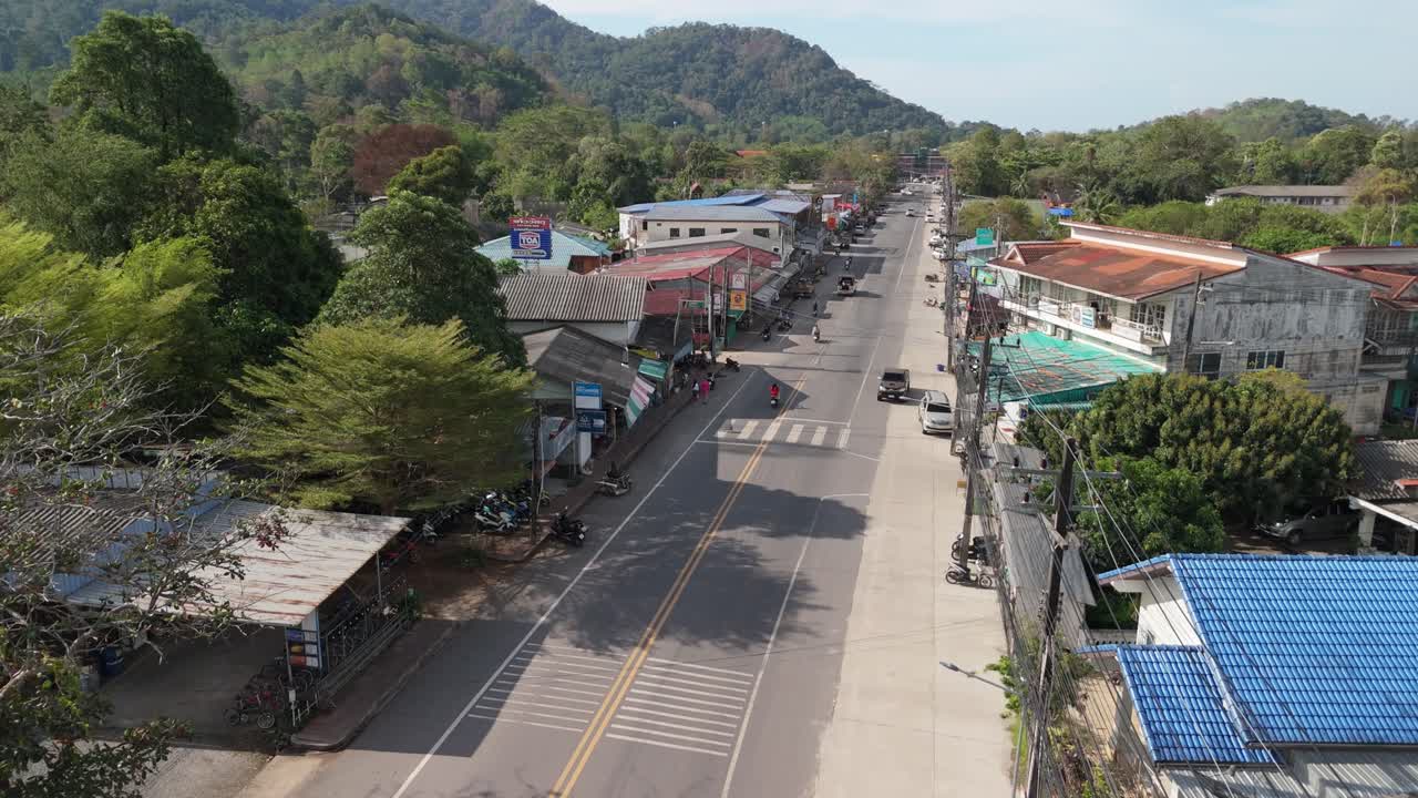 A birds-eye view of Klong Prao village on a sunny morning, roads, buildings, and resorts with light traffic in this tropical destination