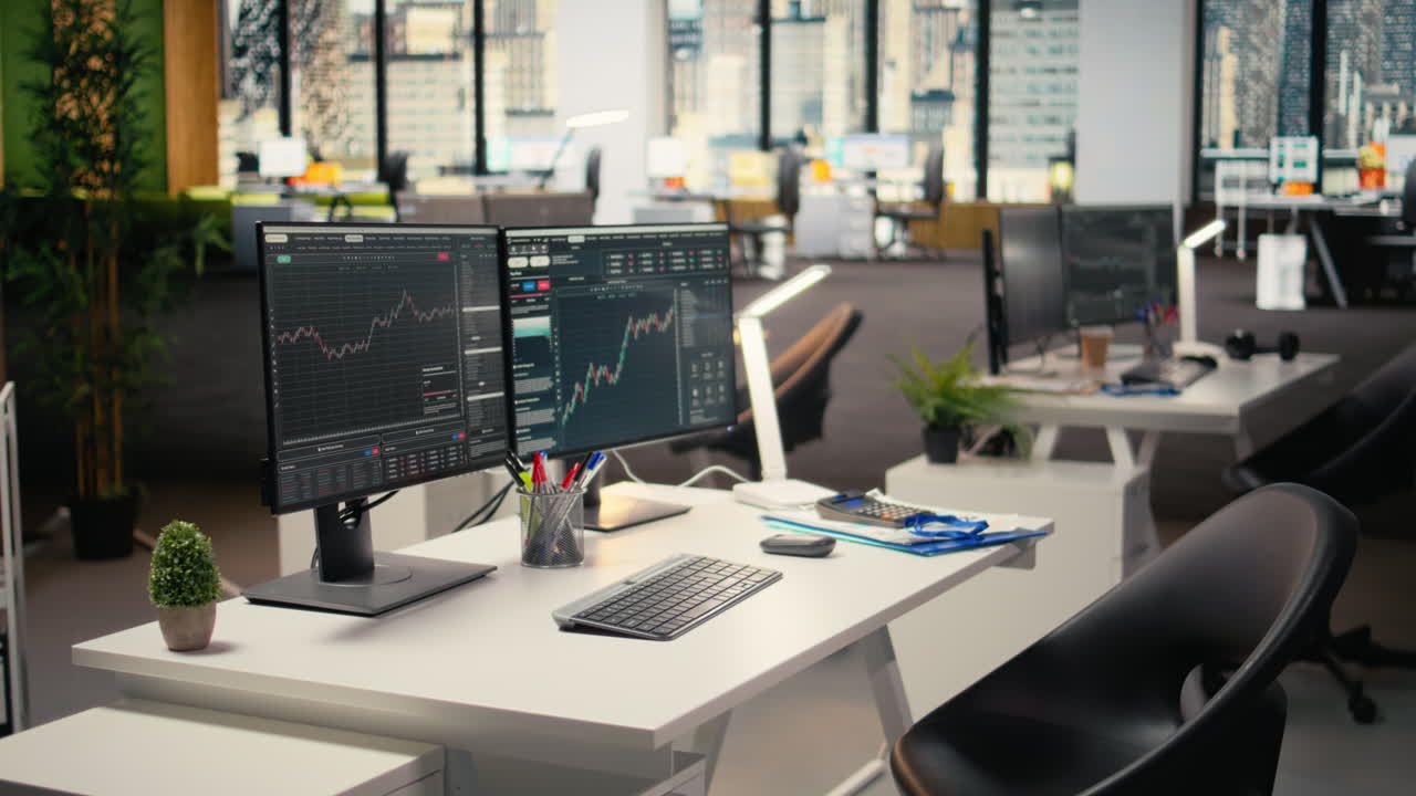 Trading software in proprietary firm office with candlestick graphs on PCs