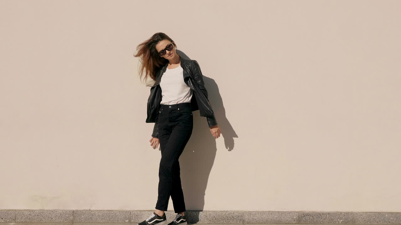 mujer elegante con chaqueta de cuero y vaqueros