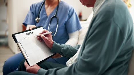 doctor and elderly patient making appointment on calendar