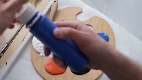 the artist prepares the paints for writing the nartina an artist works on an abstract oil painting the artist prepares the paints for writing the nartina an artist works on an abstract oil painting in a workshop the concept of painting a picture