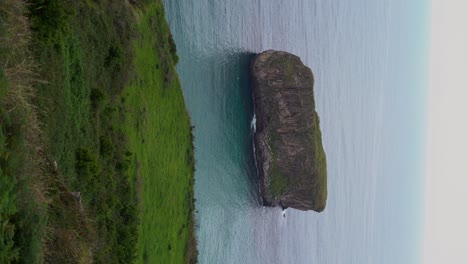 Vertical-View-Of-Castro-Ballota-Island-In-Vast-Atlantic-Ocean,-Spain