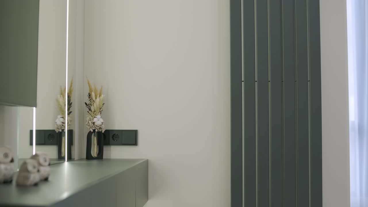 Modern living room interior design and decoration with white sofa in living area, dining table and wooden chairs, kitchen counter and cabinets. 4K video 3d rendering apartment room with balcony