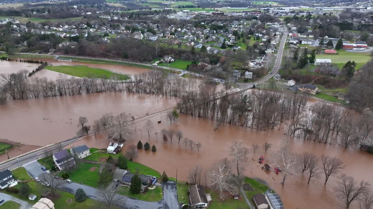 Flooded trees and roads near a suburban neighborhood, severe weather impact