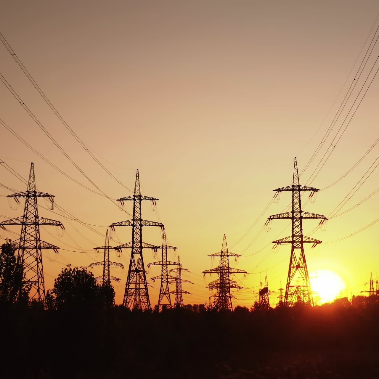 Technogenics landscape, urban. The energy of the pole in the rays of the rising sun. Posts for the transfer of high lead. Steel electric pillars concept