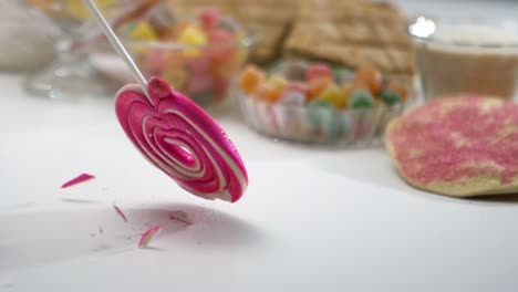 Lollipop-candy-falling-into-a-table-and-breaking---slow-motion