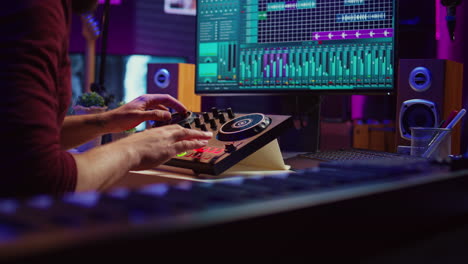 Audio engineer uses mixing board to create new song in recording home studio