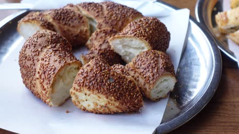 close-up of a sliced sesame bread (simit) on a metal tray