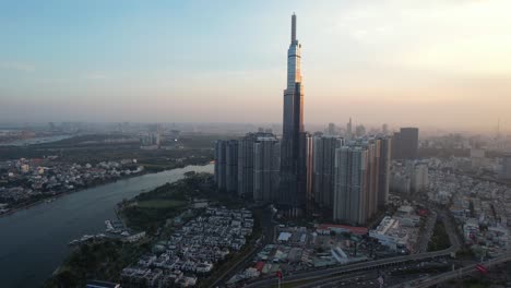 wide-aerial-of-Landmark-81-skyscraper-at-sunset-with-the-sun-reflecting-off-the-glass-on-the-building