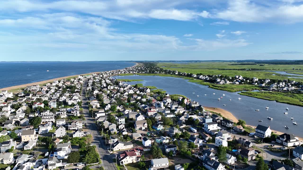 Drone view of a Massachusetts beach town and boats during a sunny summer day
