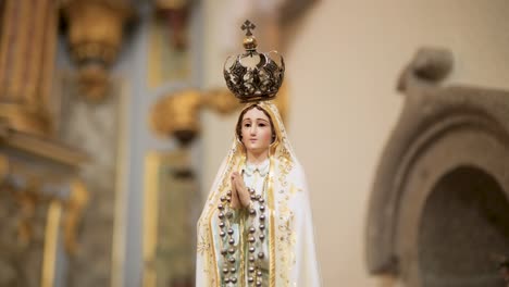 sculpture of our lady mary in a sacred catholic sanctuary church with details or art