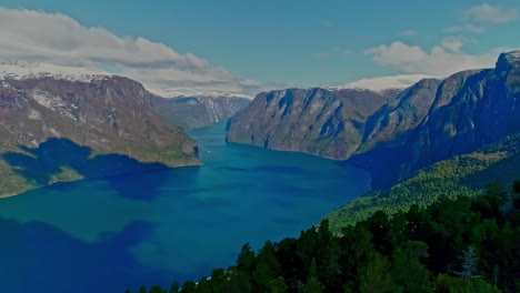 drone shot looking out over norway's beautiful water surrounded by steep mountains