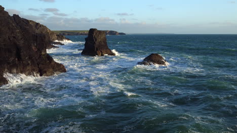 Cinematic-aerial-of-a-cornish-coastline-and-frothy-sea