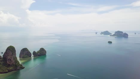 Panning-from-the-left-to-the-right-while-taking-an-aerial-drone-shot-of-the-small-islands-in-Krabi,-along-the-coast-of-Phang-Nga-Bay-in-the-southern-part-of-Thailand