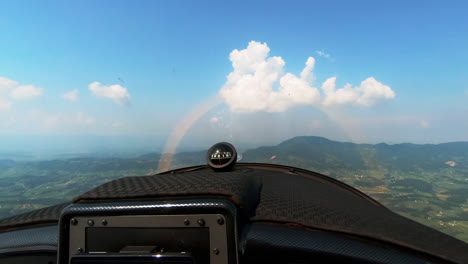 pilot perspective flying small sport airplane, cross country recreational flying, magnetic compass for navigation on dashboard, freedom above the clouds