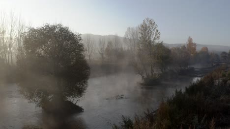 Misty-river-autumnal-morning-landscape,-aerial-view