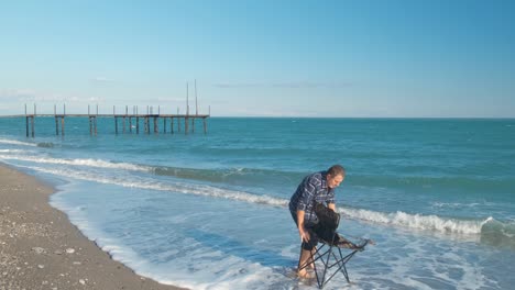 man and chair on the beack