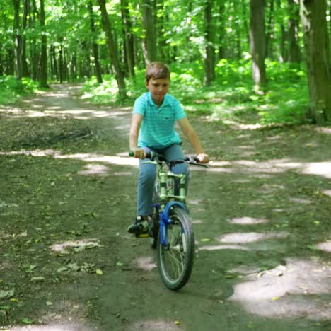 boy biking on forest trails