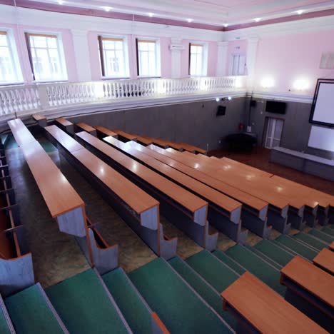 large conference hall with nobody. empty auditorium with large white board and rows of desks. modern classroom for lectures in the university