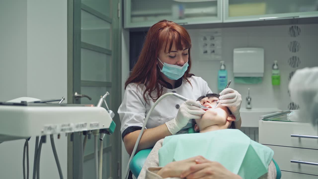 Dentist and patient in dentist office. Dental clinic.