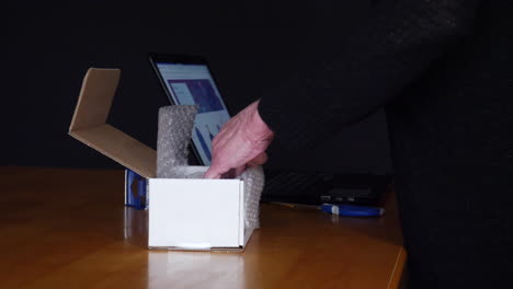 packing and shipping an item sold online in a cardboard box with bubble wrap to a customer through an auction ecommerce website