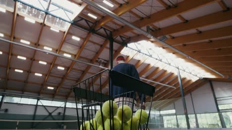 man playing tennis in indoor court