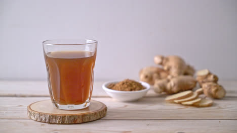 hot and sweet ginger juice glass with ginger roots - healthy drink style