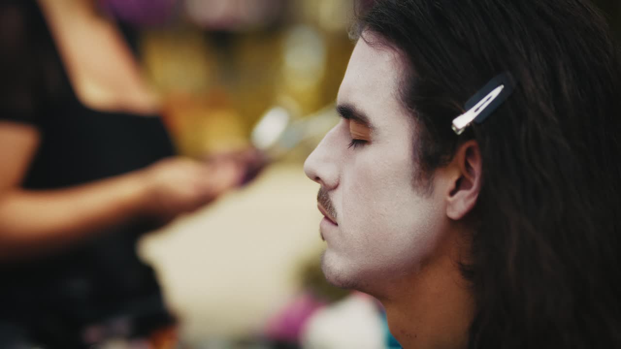 Man getting face paint for a performance