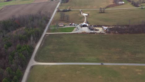 aerial dolly slide showing car driving on rural road in lonely farm borough pennsylvania, united states