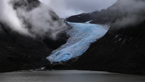 Alaska-coastal-frozen-ice-glacier-between-cloudy-mountain-fjords-landscape