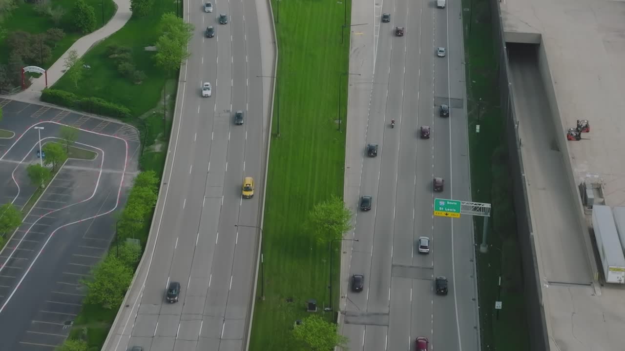 Aerial view of highways and roads in Chicago with trees and vehicles