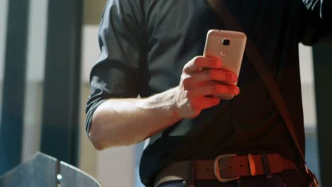 Male-commuter-using-mobile-phone-while-having-coffee-4k