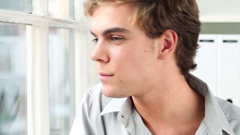 happy man looking out of window