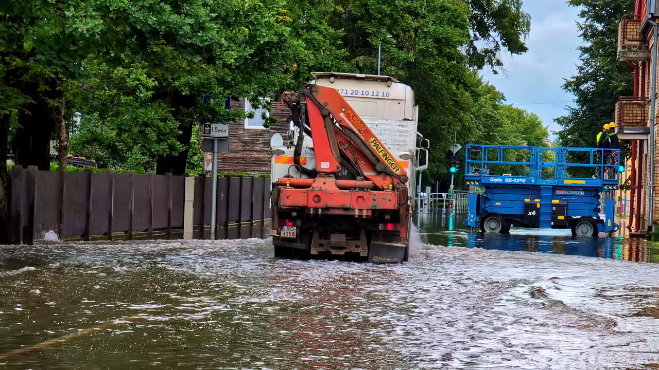 Truck moving through flooded road infrastructure, city under water Riga Latvia