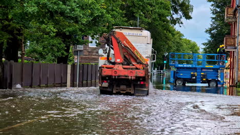 truck moving through flooded road infrastructure, city under water riga latvia