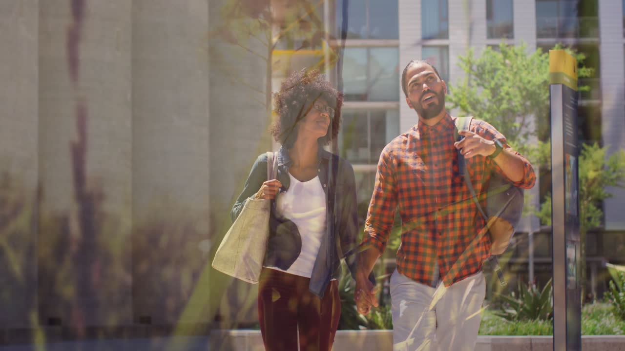 animación de hierba sobre una pareja diversa caminando y tomándose de la mano, en cámara lenta.