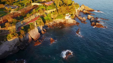 genoa's coastal cliffs and clear waters, bathed in sunset light, aerial view