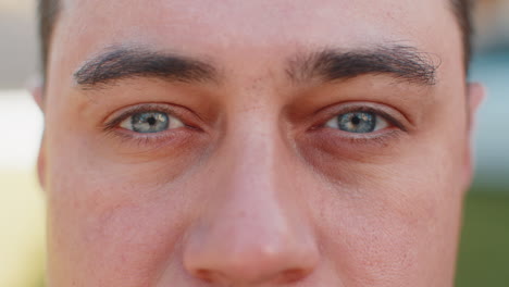 closeup macro portrait of natural happy mature attractive man with gray eyes looking at camera