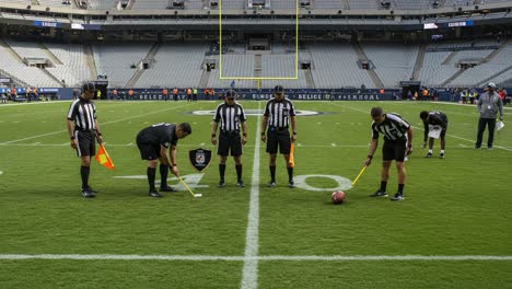 referees conduct pre-game inspection on the field: ensuring measures are in place for a fair game experience for all participants and spectators
