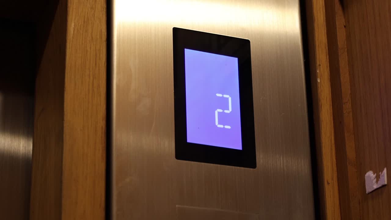 Elevator descending from fourth to first floor.