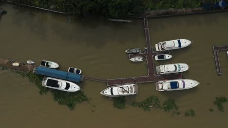 top down drone shot over river marina with luxury power boats