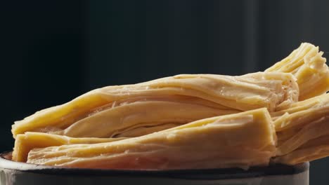 fermented soy food fuzhou, tofu skin yuba sticks or fuzhu on plate. healthy asian soy food, korean and chinese cuisine.