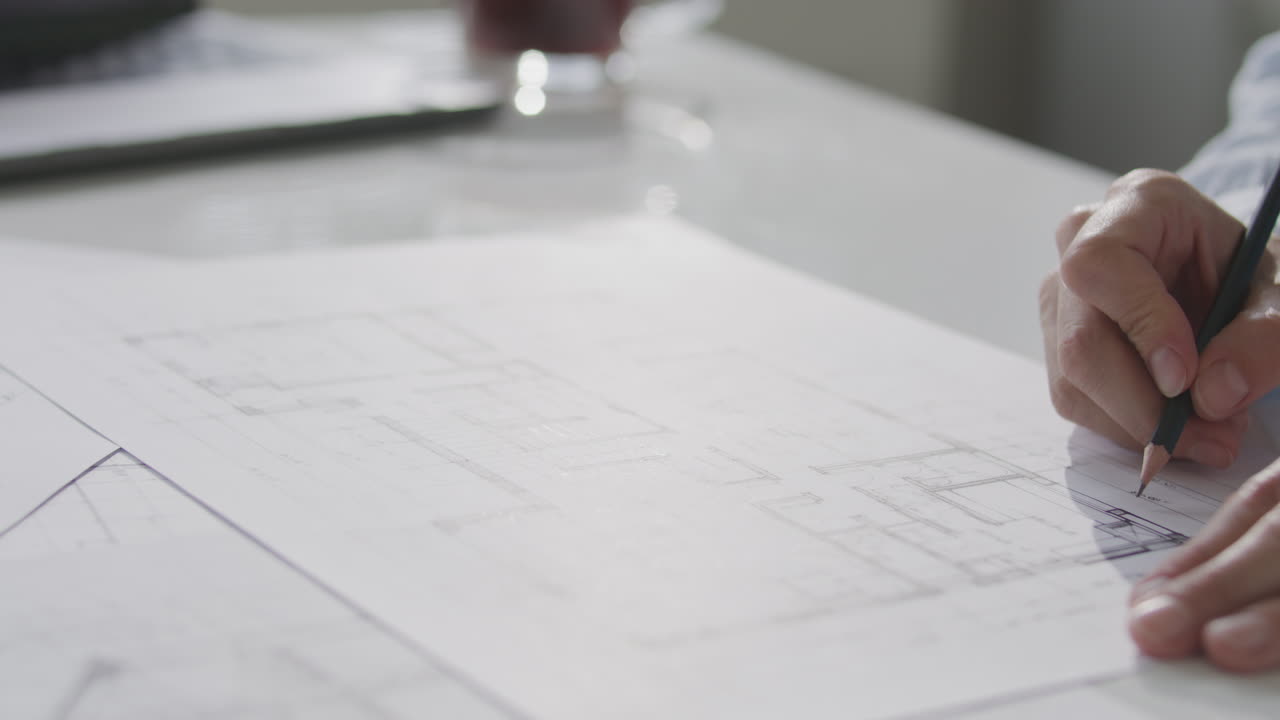 Hands of Female Architect Sketching Floor Plan on Paper