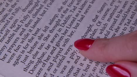 Close up of a finger pointing at a book page