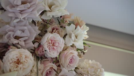 lush blush pink and white roses in a romantic wedding floral display