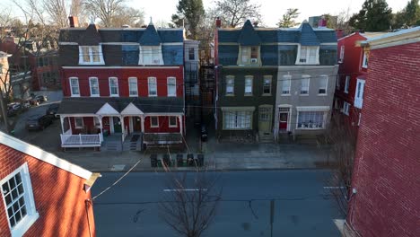 aerial pass through houses revealing row house on opposite side of street