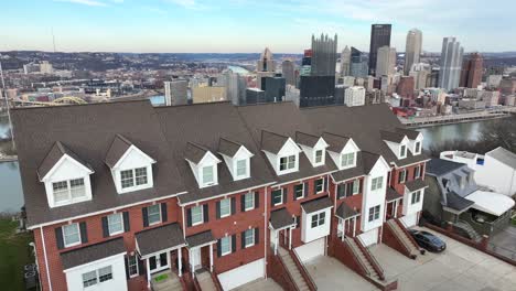 reveal of pittsburgh skyline from houses atop mt washington