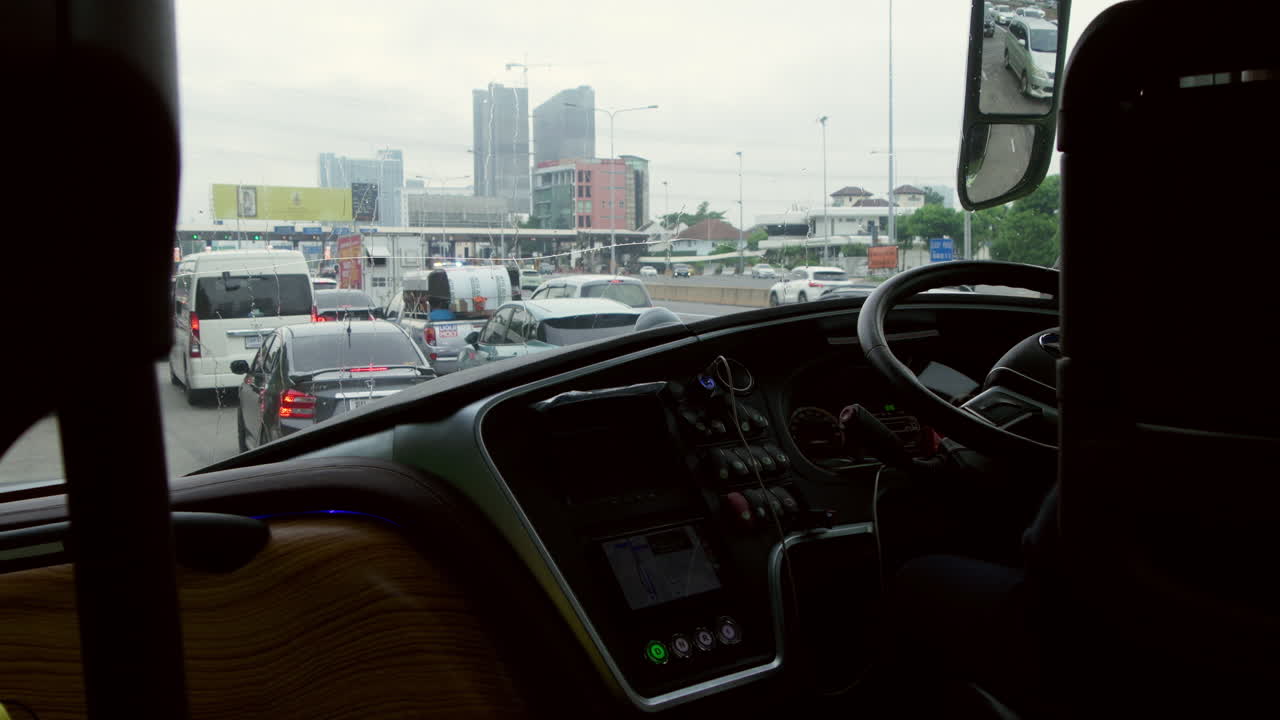 Electric bus transporting tourists on a city tour of Bangkok via the expressway with heavy traffic. Sustainable travel, modern transportation, and city exploration.