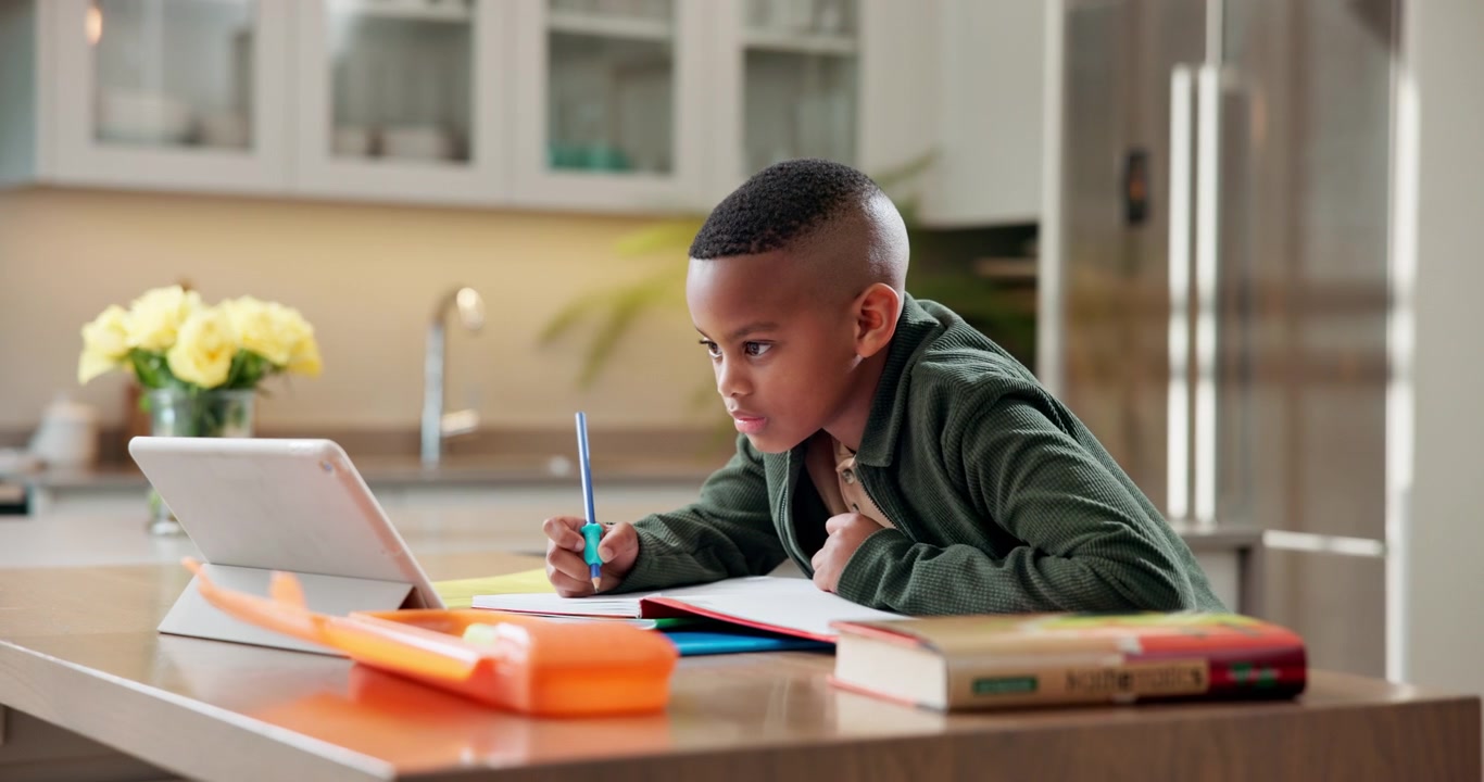 Young Boy Studying with Tablet at Home
